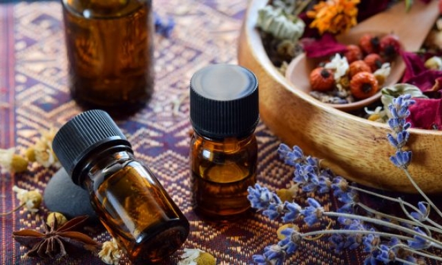 dried herbs and rose hips with essential oils for aromatherapy treatment
