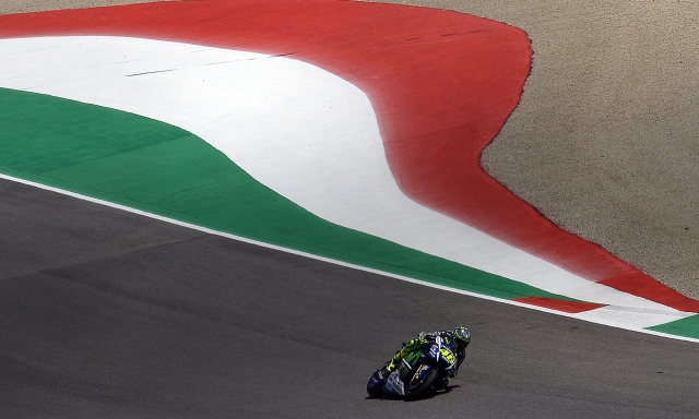 (FILES) In this file photo taken on May 31, 2015 Italy's Valentino Rossi races during the Italian MotoGP Grand Prix at the Mugello racetrack. - Moto legend and seven time top-level world champion Valentino Rossi confirmed on August 5, 2021 he will retire at the end of the year after 26 years lighting up the sport. The 42-year-old Italian signed a one-season deal with Yamaha-SRT for this campaign and it had been mooted he might ride for his own team next term, but he told a press conference ahead of this weekend's Styrian Grand Prix that he will call it a day, 12 years on from his last MotoGP title. (Photo by Filippo MONTEFORTE / AFP)