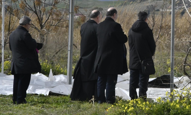 The Archbishop of Crotone Angelo Raffaele Panzetta blesses the bodies of dead migrants recovered after they washed ashore following a shipwreck, at a beach near Cutro, Crotone province, southern Italy, 26 February 2023. Italian authorities recovered at least 40 bodies on the beach and in the sea near Crotone, in the southern Italian region of Calabria, after a boat carrying migrants sank in rough seas near the coast. About forty people survived the accident, Authorities fear the death toll will climb as rescuers look for survivors. ANSA/ GIUSEPPE PIPITA