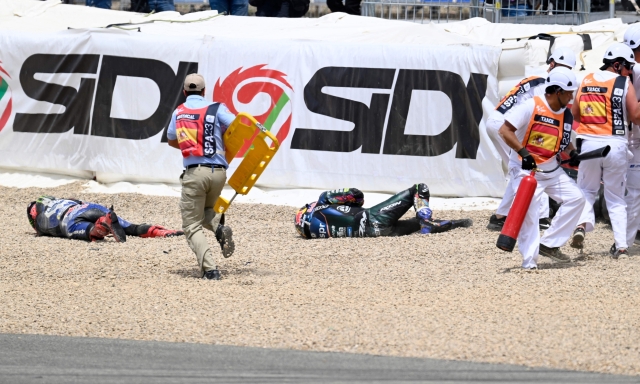 Rescuers tend to Yamaha French rider Fabio Quartararo (L) after falling during the MotoGP Spanish Grand Prix at the Jerez racetrack in Jerez de la Frontera on April 30, 2023. (Photo by JORGE GUERRERO / AFP)