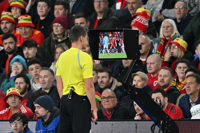  Referee Daniel Siebert checks the pitchside VAR screen before awarding a penalty following a handball incident with Ethan Ampadu of Wales during the Group J FIFA World Cup 2026 qualifier match between Wales and Belgium at Cardiff City Stadium on October 13, 2025 in Cardiff, Wales. (Photo by Dan Mullan/Getty Images)