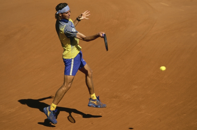 Gustavo Kuerten from Brazil plays a forehand return to Sergi Bruguera of Spain during the Men's Singles Final match at the French Open Tennis Championship on 8th June 1997 at the Stade Roland Garros in Paris, France. Gustavo Kuerten won the match and championship 6 - 3, 6 - 4, 6 - 2. (Photo by Mike Hewitt/Allsport/Getty Images)