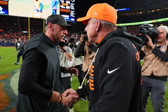 Jacksonville Jaguars head coach Liam Coen, left, and Denver Broncos head coach Sean Payton, right, shake hands after an NFL football game in Denver, Sunday, Dec. 21, 2025. (AP Photo/Jack Dempsey)