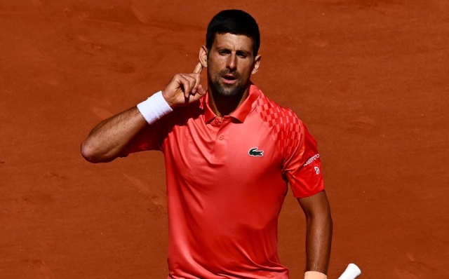 PARIS, FRANCE - MAY 29: Novak Djokovic of Serbia points to their ear as they celebrate a point against Aleksandar Kovacevic of United States during their Men's Singles First Round Match on Day Two of the 2023 French Open at Roland Garros on May 29, 2023 in Paris, France. (Photo by Clive Mason/Getty Images)