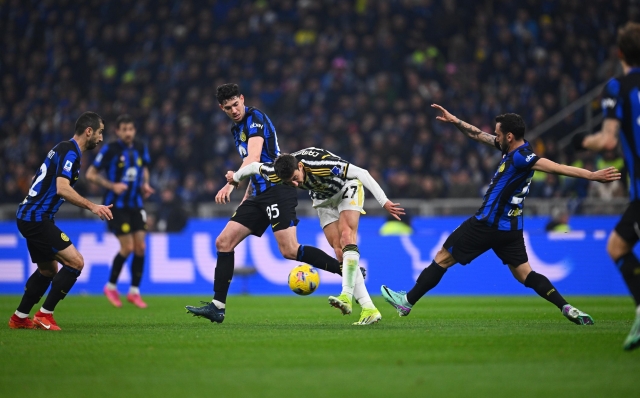 MILAN, ITALY - FEBRUARY 04: Alessandro Bastoni and Hakan Calhanoglu of FC Internazionale, in action, battle for the ball with Andrea Cambiaso of Juventus during the Serie A TIM match between FC Internazionale and Juventus - Serie A TIM  at Stadio Giuseppe Meazza on February 04, 2024 in Milan, Italy. (Photo by Mattia Ozbot - Inter/Inter via Getty Images)