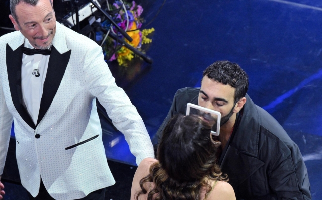 Sanremo Festival host and artistic director Amadeus (L) and AmadeusÕ wife Giovanna Civitillo (C) kissing Sanremo Festival co-host and Italian singer Marco Mengoni (R) on stage at the Ariston theatre during the 74rd Sanremo Italian Song Festival, Sanremo, Italy, 06 February 2024. The music festival will run from 06 to 10 February 2024.  ANSA/ETTORE FERRARI