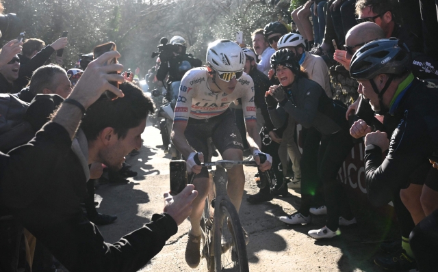 People cheer at Slovenian Tadej Pogacar, Team UAE, during the 18th one-day classic 'Strade Bianche' (White Roads) cycling race between Siena and Siena, Tuscany, on March 2, 2024. (Photo by Marco BERTORELLO / AFP)