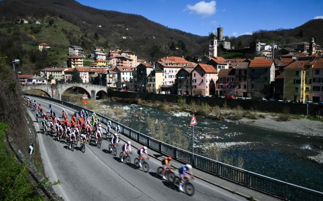 The pack of riders cycles along Campo Ligure during the 115th Milan-SanRemo one-day classic cycling race, between Pavia and SanRemo, on March 16, 2024. (Photo by Marco BERTORELLO / AFP)