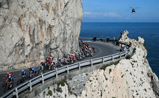 The pack rides along Capo Noli during the 115th Milan-SanRemo one-day classic cycling race, between Pavia and SanRemo, on March 16, 2024. (Photo by Marco BERTORELLO / AFP)