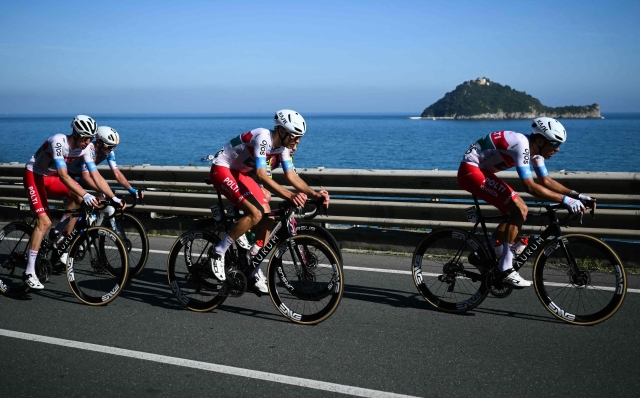Team Polti Kometa Italian rider Mirco Maestri (R) and Team Polti Kometa Italian rider Andrea Pietrobon (C) ride in breakaway during the 115th Milan-SanRemo one-day classic cycling race, between Pavia and SanRemo, on March 16, 2024. (Photo by Marco BERTORELLO / AFP)