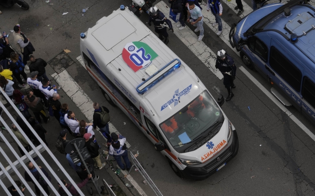 An ambulance bears on its rooftop the Scudetto (the Italian soccer championship title) as thousands of fans cheer the triumphant Inter Milan soccer team players parading on a bus and celebrating their 20th Italian Serie A top league title, in Milan, Italy, Sunday, April 28, 2024. (AP Photo/Luca Bruno)
