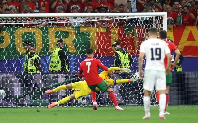 FRANKFURT AM MAIN, GERMANY - JULY 01: Jan Oblak of Slovenia saves the penalty kick from Cristiano Ronaldo of Portugal during the UEFA EURO 2024 round of 16 match between Portugal and Slovenia at Frankfurt Arena on July 01, 2024 in Frankfurt am Main, Germany. (Photo by Lars Baron/Getty Images)