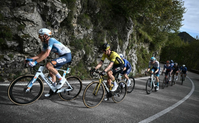 Team DSM-Firmenich PostNL's Dutch rider Martijn Tusveld (L) and Team Visma - Lease a Bike team's Dutch rider Wilco Kelderman (2nd L) lead a breakaway in the ascent of Selvino the 118th edition of the Giro di Lombardia (Tour of Lombardy), a 252km cycling race from Bergamo to Como on October 12, 2024. (Photo by Marco BERTORELLO / AFP)