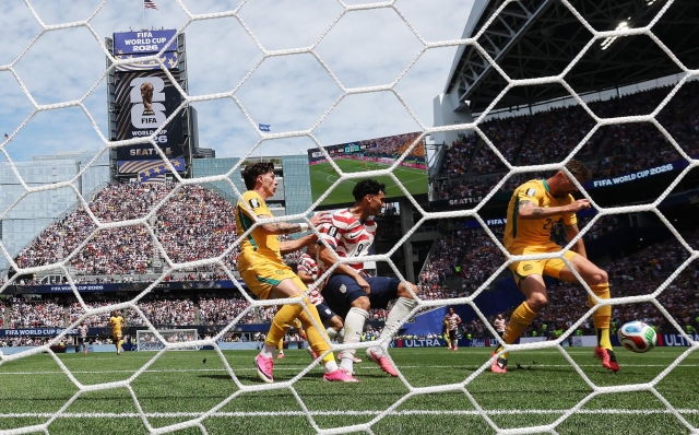 SEATTLE, WASHINGTON - JUNE 19: (EDITOR'S NOTE: Image was captured using a remote camera from behind the goal.) Cameron Burgess #21 of Australia scores an own goal, first goal for the United States during the FIFA World Cup 2026 Group D match between USA and Australia at Seattle Stadium on June 19, 2026 in Seattle, Washington. Emilee Chinn/Getty Images/AFP (Photo by Emilee Chinn / GETTY IMAGES NORTH AMERICA / Getty Images via AFP)