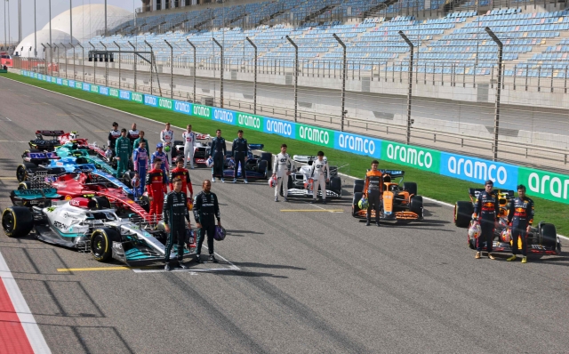 Drivers pose on the starting grid during the first day of Formula One (F1) pre-season testing at the Bahrain International Circuit in the city of Sakhir on March 12, 2021. (Photo by Giuseppe CACACE / AFP)