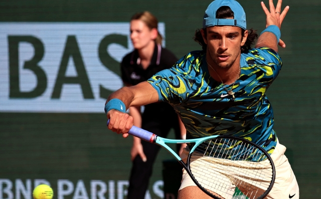 Italy's Lorenzo Musetti plays a backhand return to Italy's Jannik Sinner during the Monte-Carlo ATP Masters Series tournament quarter final tennis match in Monte Carlo on April 14, 2023. (Photo by Valery HACHE / AFP)
