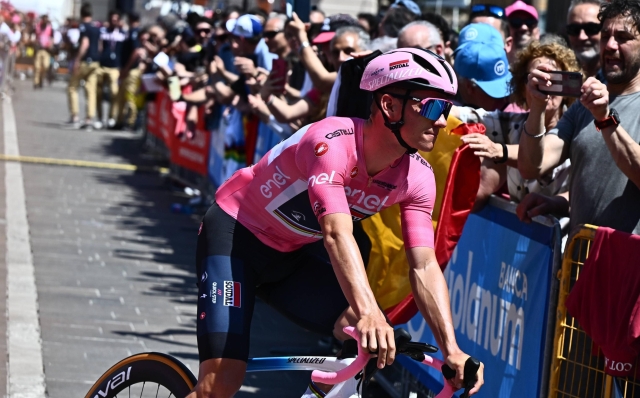 Belgian rider Remco Evenepoel of team Soudal Quick-Step  wearing the overall leader's pink jersey, greets the crowd signig in ahead the departure of the 02th stage of the 2023 Giro d'Italia cycling race over 202 km from Teramo to San Salvo, Italy, 07 May. ANSA/LUCA ZENNARO