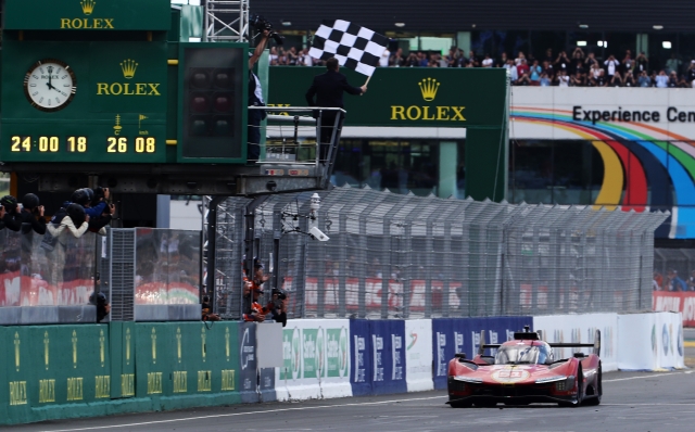 LE MANS, FRANCE - JUNE 11: The race winning Ferrari AF Corse Ferrari 499P of  Alessandro Pier Guidi (driving), James Calado and Antonio Giovinazzi takes the checkered flag at the finish of the 100th anniversary 24 Hours of Le Mans race at the Circuit de la Sarthe June 11, 2023 in Le Mans, France. (Photo by Ker Robertson/Getty Images)