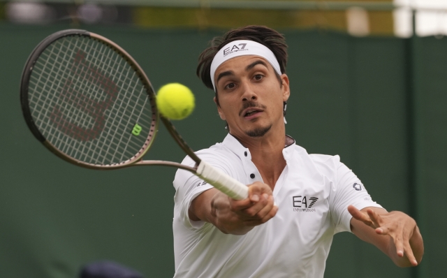 Italy's Lorenzo Sonego plays a return to Italy's Matteo Berrettini during the first round men's singles match on day two of the Wimbledon tennis championships in London, Tuesday, July 4, 2023. (AP Photo/Alberto Pezzali)