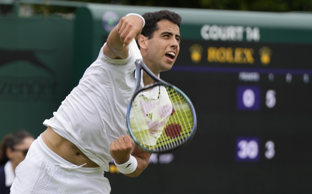 Spain's Jaume Munar serves to Italy's Lorenzo Musetti during the singles match on day four of the Wimbledon tennis championships in London, Thursday, July 6, 2023. (AP Photo/Alastair Grant)