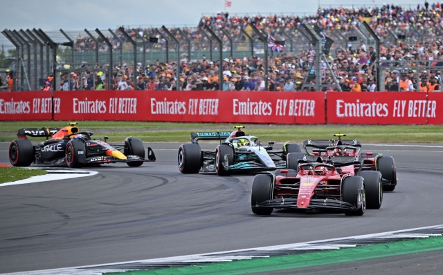 Ferrari's Monegasque driver Charles Leclerc leads Ferrari's Spanish driver Carlos Sainz Jr, Mercedes' British driver Lewis Hamilton and Red Bull Racing's Mexican driver Sergio Perez following a restart by safety car during the Formula One British Grand Prix at the Silverstone motor racing circuit in Silverstone, central England on July 3, 2022. (Photo by JUSTIN TALLIS / AFP)