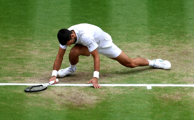 LONDON, ENGLAND - JULY 16: Novak Djokovic of Serbia slips in the Men's Singles Final against Carlos Alcaraz of Spain on day fourteen of The Championships Wimbledon 2023 at All England Lawn Tennis and Croquet Club on July 16, 2023 in London, England. (Photo by Patrick Smith/Getty Images)