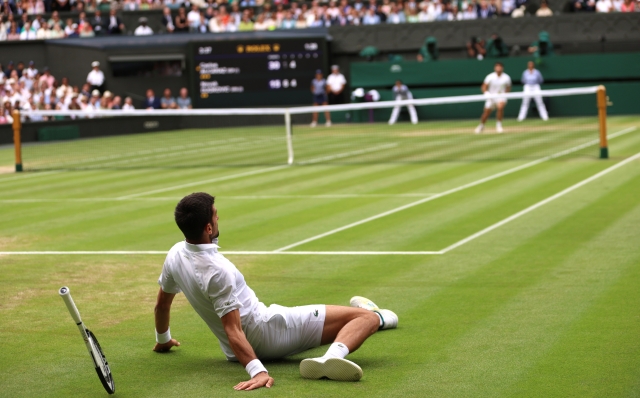 LONDON, ENGLAND - JULY 16: Novak Djokovic of Serbia falls in the Men's Singles Final against Carlos Alcaraz of Spain on day fourteen of The Championships Wimbledon 2023 at All England Lawn Tennis and Croquet Club on July 16, 2023 in London, England. (Photo by Clive Brunskill/Getty Images)