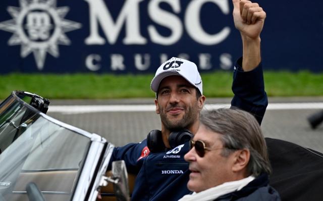 McLaren's Australian driver Daniel Ricciardo gestures from a vintage car as he takes part in the  driver's parade ahead of the Formula One Belgian Grand Prix at the Spa-Francorchamps Circuit in Spa on July 30, 2023. (Photo by JOHN THYS / AFP)