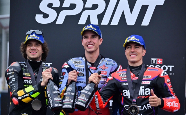 (From L) Second-placed Mooney VR46 Racing's Italian rider Marco Bezzecchi, first-placed Gresini Racing MotoGP's Spanish rider Alex Marquez and thrid-placed Aprilia Racing's Spanish rider Maverick Vinales celebrate duirng the podium ceremony after competing in the Moto GP sprint race of the motorcycling British Grand Prix at Silverstone circuit in Northamptonshire, central England, on August 5, 2023. (Photo by Ben Stansall / AFP)