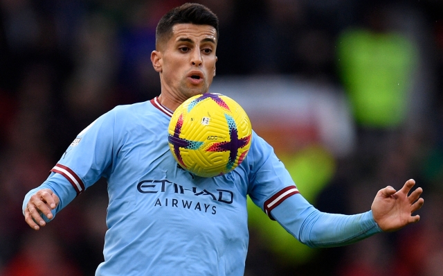 Manchester City's Portuguese defender Joao Cancelo controls the ball during the English Premier League football match between Manchester United and Manchester City at Old Trafford in Manchester, north west England, on January 14, 2023. (Photo by Oli SCARFF / AFP) / RESTRICTED TO EDITORIAL USE. No use with unauthorized audio, video, data, fixture lists, club/league logos or 'live' services. Online in-match use limited to 120 images. An additional 40 images may be used in extra time. No video emulation. Social media in-match use limited to 120 images. An additional 40 images may be used in extra time. No use in betting publications, games or single club/league/player publications. /