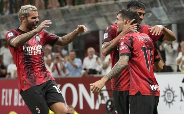 AC Milan's Christian Pulisic celebrates with his teammates after scoring his side's first goal during a Serie A soccer match between AC Milan and ,Torino at the San Siro stadium in Milan, Italy, Saturday, Aug. 26, 2023. (AP Photo/Luca Bruno)