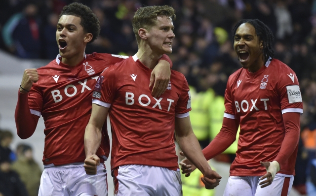 Nottingham Forest's Ryan Yates, center, celebrates with teammates Brennan Johnson, left, and Djed Spence after scoring his team's second goal during the English FA Cup fifth round soccer match between Nottingham Forest and Huddersfield Town, at the City Ground, in Nottingham, England, Monday, March 7, 2022. (AP Photo/Rui Vieira)