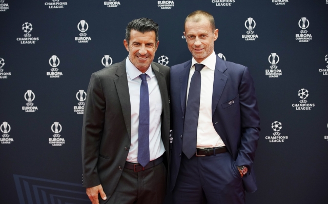 UEFA President Aleksander Ceferin, right, and former soccer star Luis Figo pose for a picture before the 2023/24 UEFA Champions League group stage draw at the Grimaldi Forum in Monaco, Thursday, Aug. 31, 2013. (AP Photo/Daniel Cole)