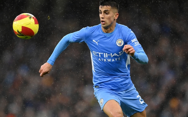MANCHESTER, ENGLAND - FEBRUARY 05: Joao Cancelo of Manchester City in action during the Emirates FA Cup Fourth Round match between Manchester City and Fulham at Etihad Stadium on February 05, 2022 in Liverpool, England. (Photo by Clive Mason/Getty Images)