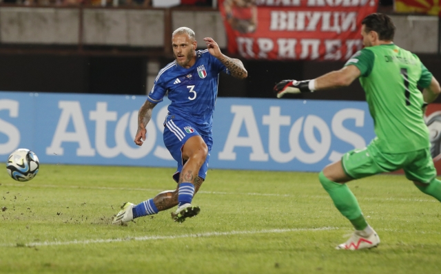Italy's Federico Dimarco, left, tries to score past North Macedonia goalkeeper Stole Dimitrievski during the Euro 2024 group C qualifying soccer match between North Macedonia and Italy at National Arena Todor Proeski in Skopje, North Macedonia, Saturday, Sept. 9, 2023. (AP Photo/Boris Grdanoski)