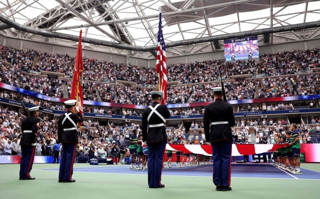 NEW YORK, NEW YORK - SEPTEMBER 10: A large American flag is displayed over the court as American operatic baritone Will Liverman performs "America The Beautiful" prior to the Men's Singles Final match between Novak Djokovic of Serbia and Daniil Medvedev of Russia on Day Fourteen of the 2023 US Open at the USTA Billie Jean King National Tennis Center on September 10, 2023 in the Flushing neighborhood of the Queens borough of New York City.   Elsa/Getty Images/AFP (Photo by ELSA / GETTY IMAGES NORTH AMERICA / Getty Images via AFP)