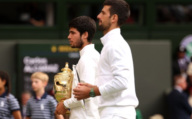 LONDON, ENGLAND - JULY 16: Carlos Alcaraz of Spain (L) holds the Men's Singles Trophy alongside Novak Djokovic of Serbia (R) with the Men's Singles Runner's Up Plate following the Men's Singles Final on day fourteen of The Championships Wimbledon 2023 at All England Lawn Tennis and Croquet Club on July 16, 2023 in London, England. (Photo by Julian Finney/Getty Images)