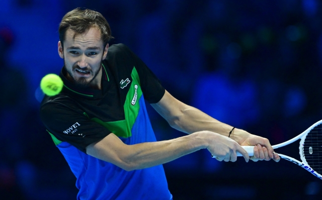 Russia's Daniil Medvedev returns to Italy's Jannik Sinner during their semi-final match at the ATP Finals tennis tournament in Turin on November 18, 2023. (Photo by Tiziana FABI / AFP)