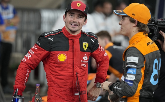 Ferrari driver Charles Leclerc of Monaco, left, chats with McLaren driver Oscar Piastri of Australia after qualifying session ahead of the Abu Dhabi Formula One Grand Prix at the Yas Marina Circuit, Abu Dhabi, UAE, Saturday, Nov. 25, 2023. (AP Photo/Kamran Jebreili)