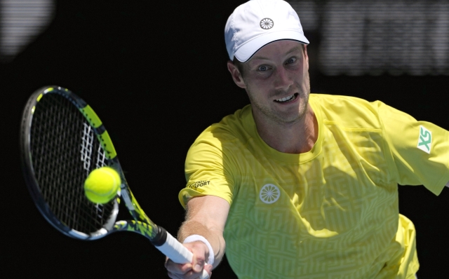 Botic van de Zandschulp of the Netherlands plays a forehand return to Italy's Jannick Sinner during their first round match at the Australian Open tennis championships at Melbourne Park, Melbourne, Australia, Sunday, Jan. 14, 2024. (AP Photo/Andy Wong)