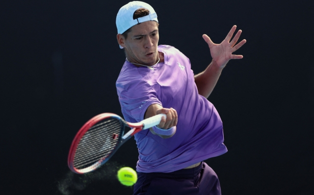 Argentina's Sebastian Baez hits a return against Colombia's Daniel Galan during their men's singles match on day four of the Australian Open tennis tournament in Melbourne on January 17, 2024. (Photo by Martin KEEP / AFP) / -- IMAGE RESTRICTED TO EDITORIAL USE - STRICTLY NO COMMERCIAL USE --