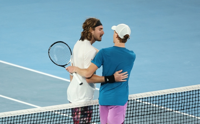 Greece's Stefanos Tsitsipas greets Italy's Jannik Sinner after winning their men's singles match on day seven of the Australian Open tennis tournament in Melbourne on January 22, 2023. (Photo by Martin KEEP / AFP) / -- IMAGE RESTRICTED TO EDITORIAL USE - STRICTLY NO COMMERCIAL USE --