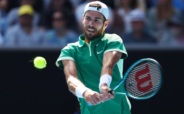 MELBOURNE, AUSTRALIA - JANUARY 21: Karen Khachanov plays a backhand in their round four singles match against Jannik Sinner of Italy during the 2024 Australian Open at Melbourne Park on January 21, 2024 in Melbourne, Australia. (Photo by Phil Walter/Getty Images)