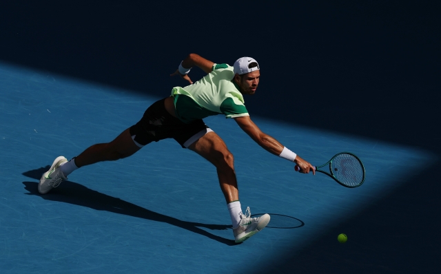 MELBOURNE, AUSTRALIA - JANUARY 21: Karen Khachanov plays a backhand in their round four singles match against Jannik Sinner of Italy during the 2024 Australian Open at Melbourne Park on January 21, 2024 in Melbourne, Australia. (Photo by Darrian Traynor/Getty Images)