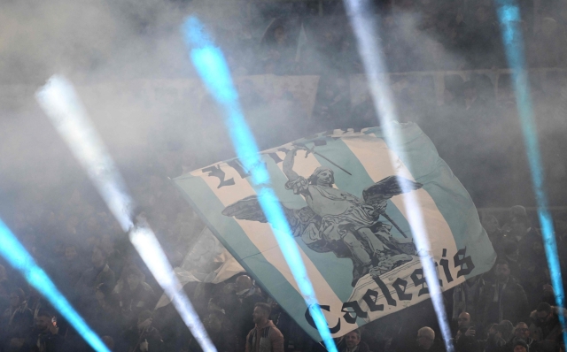 Lazio's supporters wave giant flags before during the UEFA Champions League last 16 first leg between Lazio and Bayern Munich at the Olympic stadium on February 14, 2024 in Rome. (Photo by Alberto PIZZOLI / AFP)