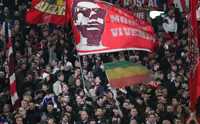 Bayern's supporters wave flags before the UEFA Champions League last 16 first leg between Lazio and Bayern Munich at the Olympic stadium on February 14, 2024 in Rome. (Photo by Alberto PIZZOLI / AFP)