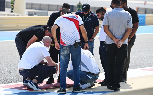 BAHRAIN, BAHRAIN - FEBRUARY 23: Niels Wittich, FIA Race Director and track workers inspect a loose drain cover that caused a red flag delay during day three of F1 Testing at Bahrain International Circuit on February 23, 2024 in Bahrain, Bahrain. (Photo by Rudy Carezzevoli/Getty Images)