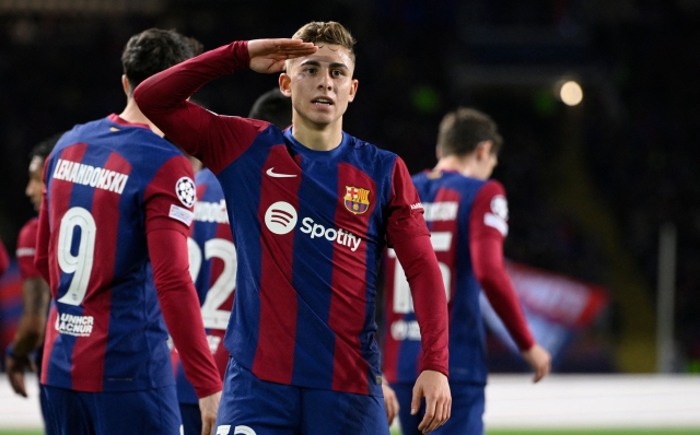 Barcelona's Spanish midfielder #32 Fermin Lopez celebrates scoring the opening goal during the UEFA Champions League last 16 second leg football match between FC Barcelona and SSC Napoli at the Estadi Olimpic Lluis Companys in Barcelona on March 12, 2024. (Photo by Josep LAGO / AFP)