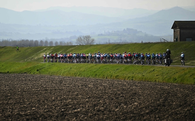 The pack of riders cycles during the 115th Milan-SanRemo one-day classic cycling race, between Pavia and SanRemo, on March 16, 2024. (Photo by Marco BERTORELLO / AFP)