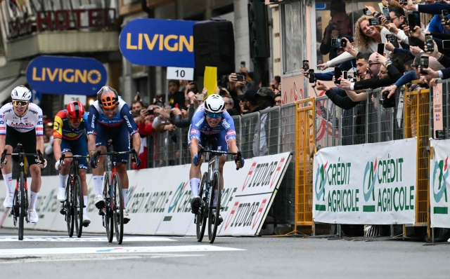 Alpecin-Deceuninck's Belgian rider Jasper Philipsen (R) cycles to cross the finish line and win the 115th Milan-SanRemo one-day classic cycling race, between Pavia and SanRemo, on March 16, 2024. (Photo by Marco BERTORELLO / AFP)